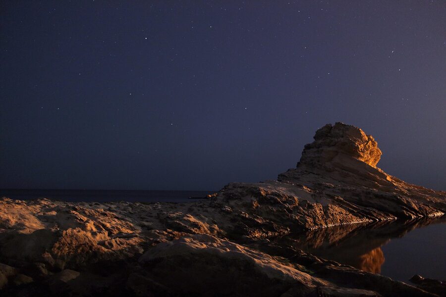 The Monument to the Fallen at Passetto in Ancona lit at night on the cliff above the Adriatic