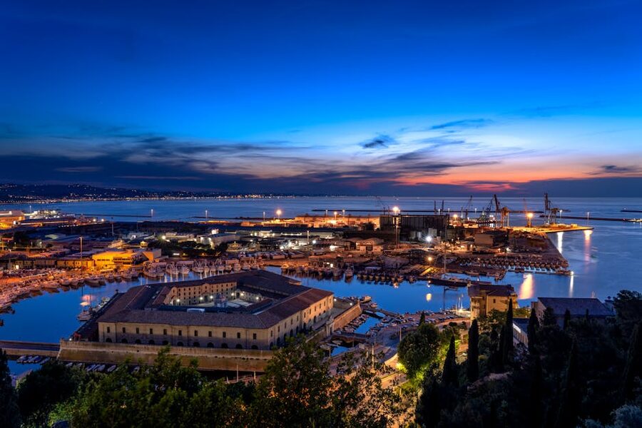 Aerial view of Ancona port at sunset with the Adriatic sea, docks and old town on the hill
