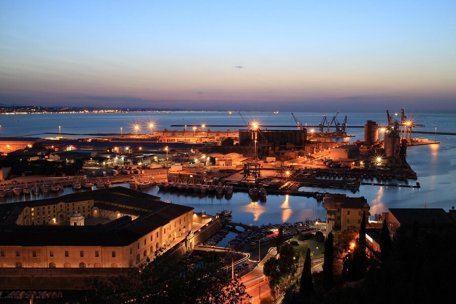 Ancona port at sunset with the Adriatic sea, boats and the old town on the hillside