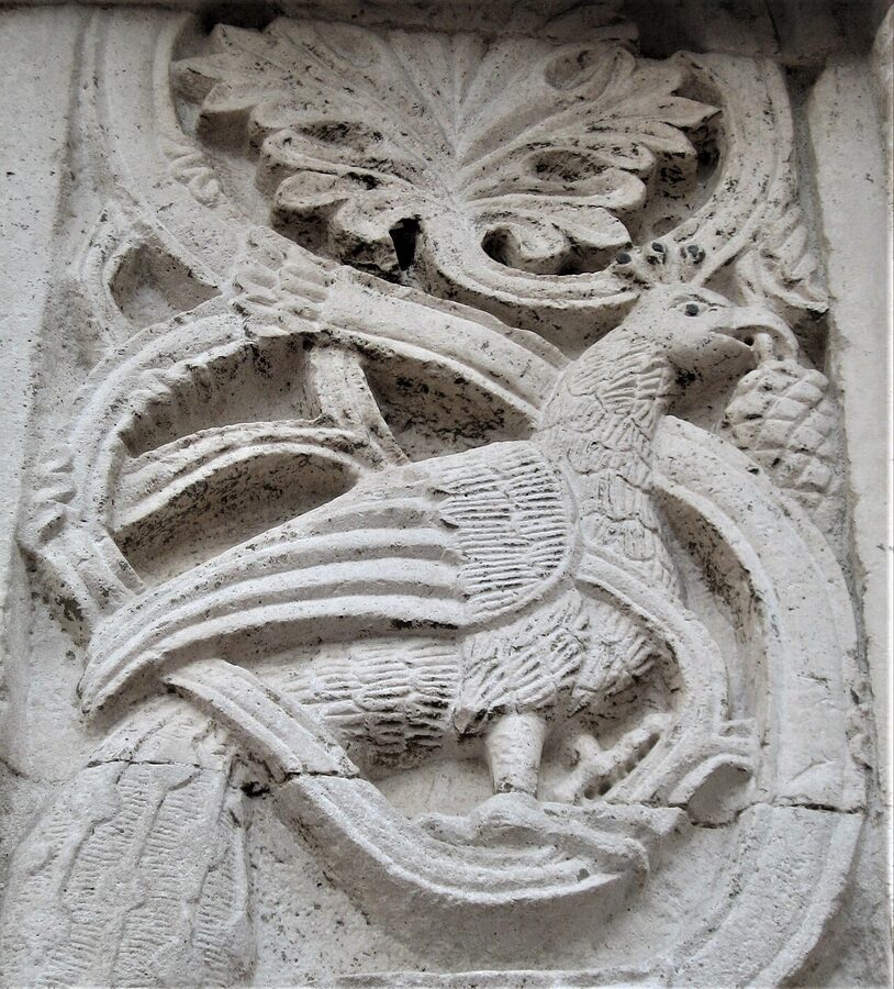 The Romanesque façade of Santa Maria della Piazza in Ancona, with detailed carved lions and biblical reliefs