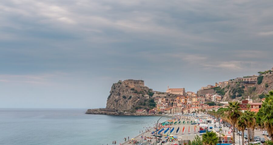 Scilla village in the Strait of Messina with colourful houses along the sea and a castle above