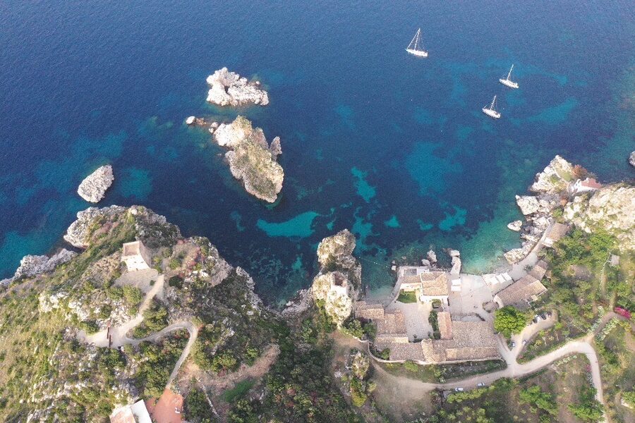 The Tonnara and Faraglioni of Scopello — limestone sea stacks rising from the Tyrrhenian Sea