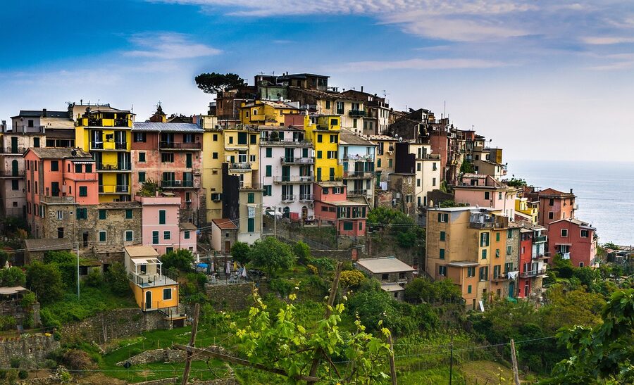 Corniglia hilltop village with terraced vineyards and Ligurian coastline stretching into the distance