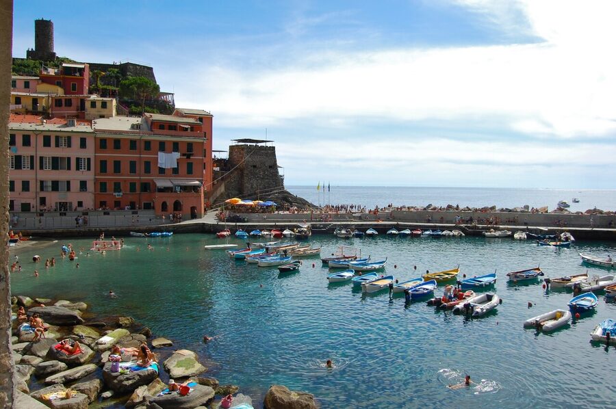 Vernazza from above the harbour with the castle, church and village buildings compact around the cove