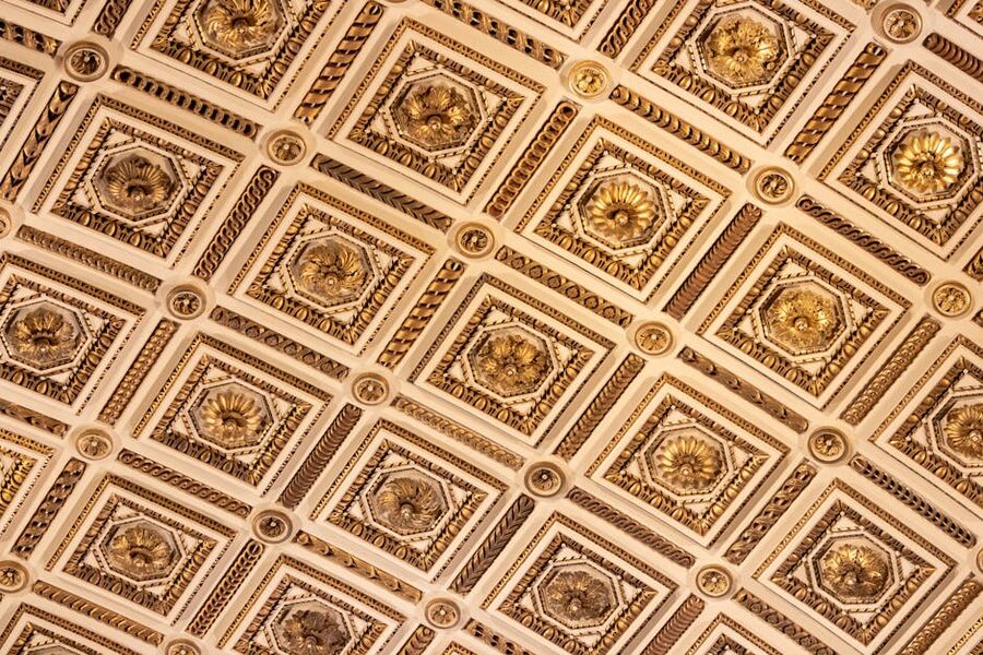 The ornate gold and white ceiling of the Uffizi Gallery in Florence