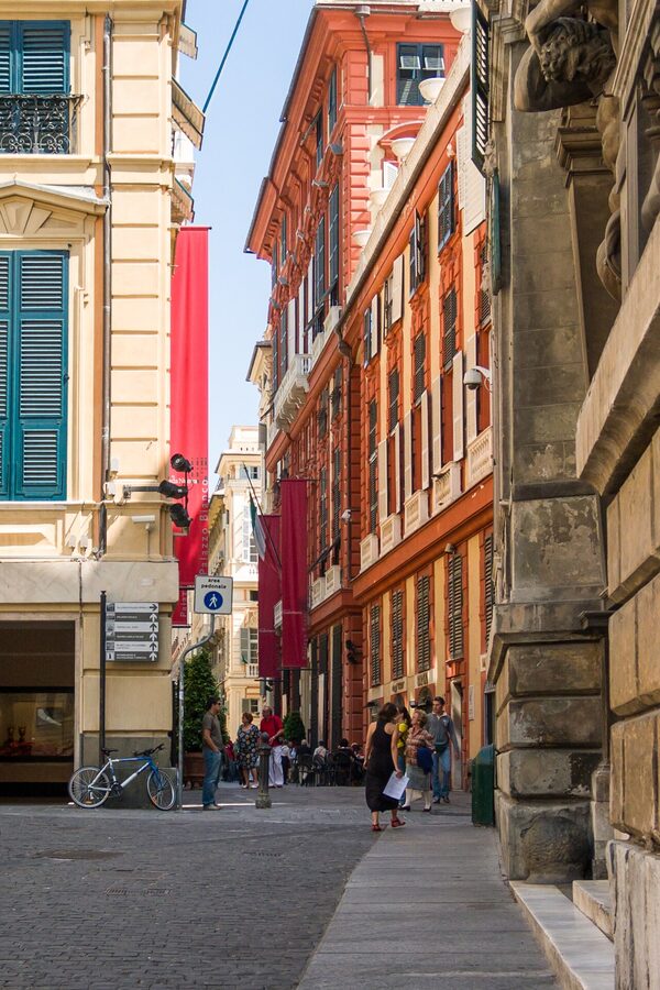 Via Garibaldi in Genoa with Palazzo Rosso's red façade and the UNESCO Palazzi dei Rolli