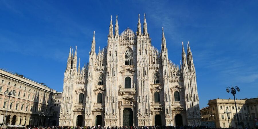 Milan Duomo cathedral with its Gothic spires and white marble façade on a bright day