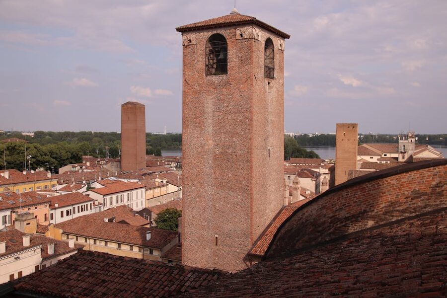 Aerial view of Mantova's historic towers and the Palazzo Ducale against a summer sky