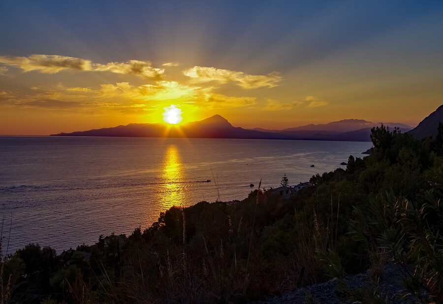 Sunset over the sea at Maratea with golden light over the Tyrrhenian and mist on the horizon