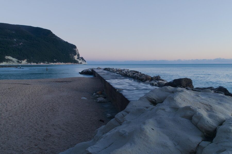 The sea and sky at dawn from the Conero headland, with the outline of hills at sunrise