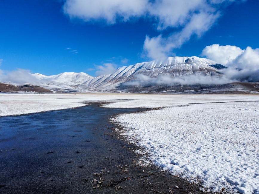 The Sibillini mountains in winter, snow-capped peaks against a deep blue sky