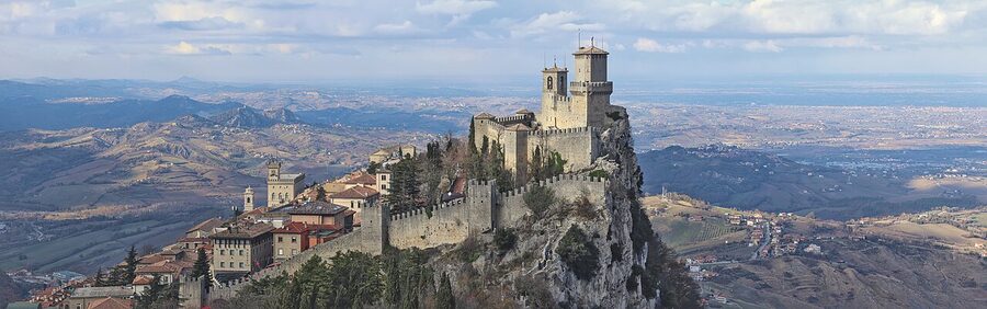 Guaita Fortress on top of Monte Titano, San Marino, with the Adriatic coastline visible in the distance