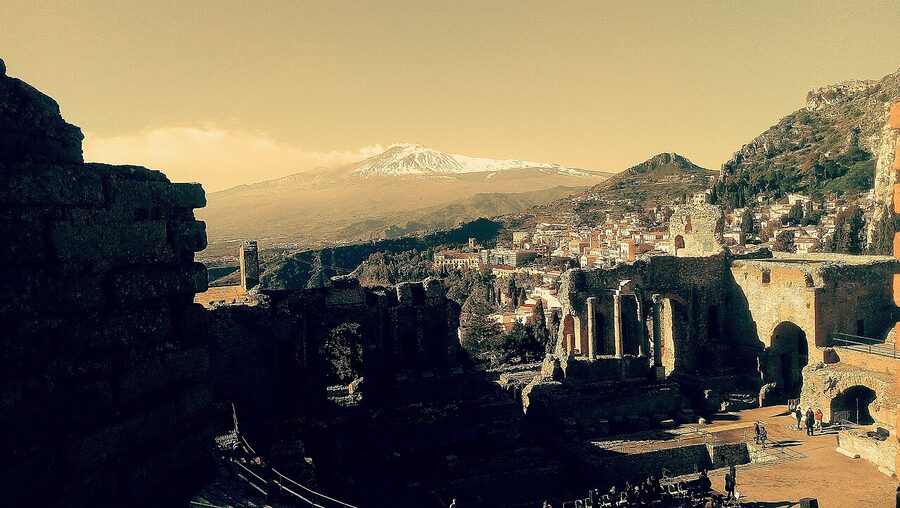 The ancient Greek-Roman theatre of Taormina with Mount Etna and the Ionian coast in the background