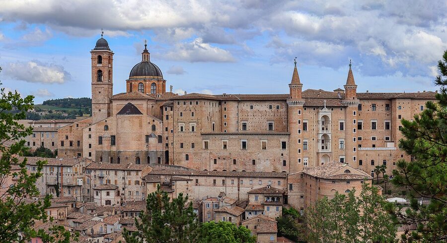 Panorama of Urbino at sunset with the Palazzo Ducale towers silhouetted against the sky